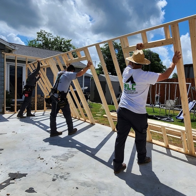 Construction workers working on framing for home addition.